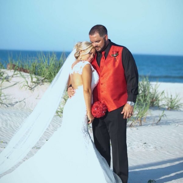 Bride and groom at the beach at Guy Harvey Resort