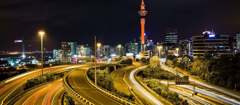 Busy Auckland city by night with the Sky Tower